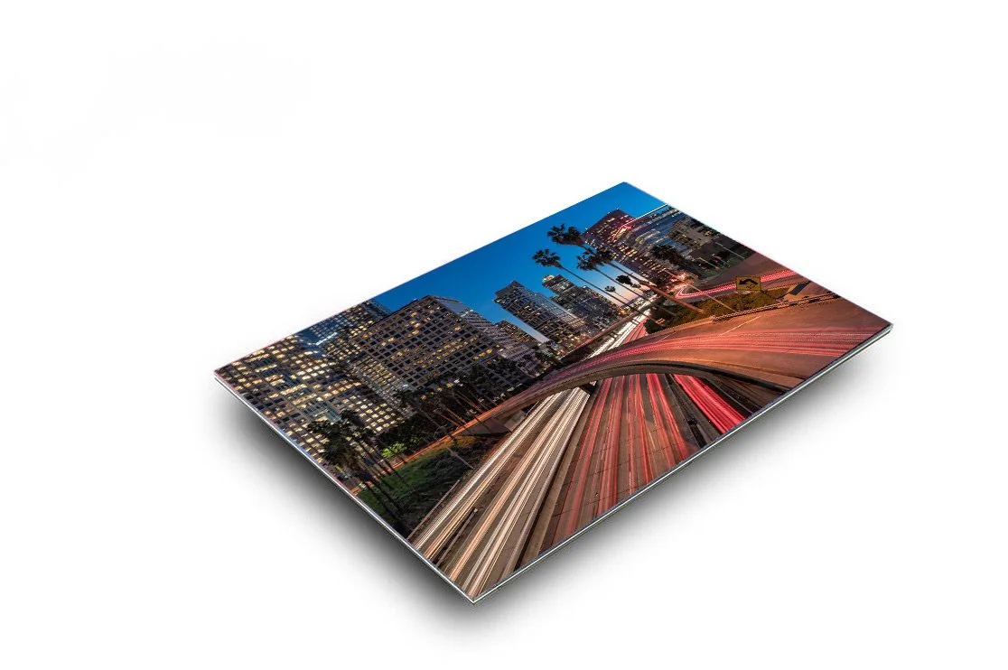 Acrylic print of 'Downtown LA at Twilight' showcasing the vibrant evening lights and bustling traffic of Los Angeles, encapsulating the dynamic city life within a sleek, modern wall art piece from TomsWorldCollection.